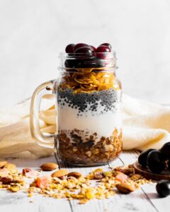 Savor a nutritious parfait featuring chia seeds, oats, and fresh fruit in a jar, perfect for a healthy breakfast.