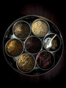 Mustard Seeds Premium 500g - view of assorted Indian spices in a traditional container, highlighting vibrant textures.